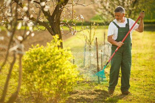 Gardening team writing a free quote after inspecting a Golders Green property